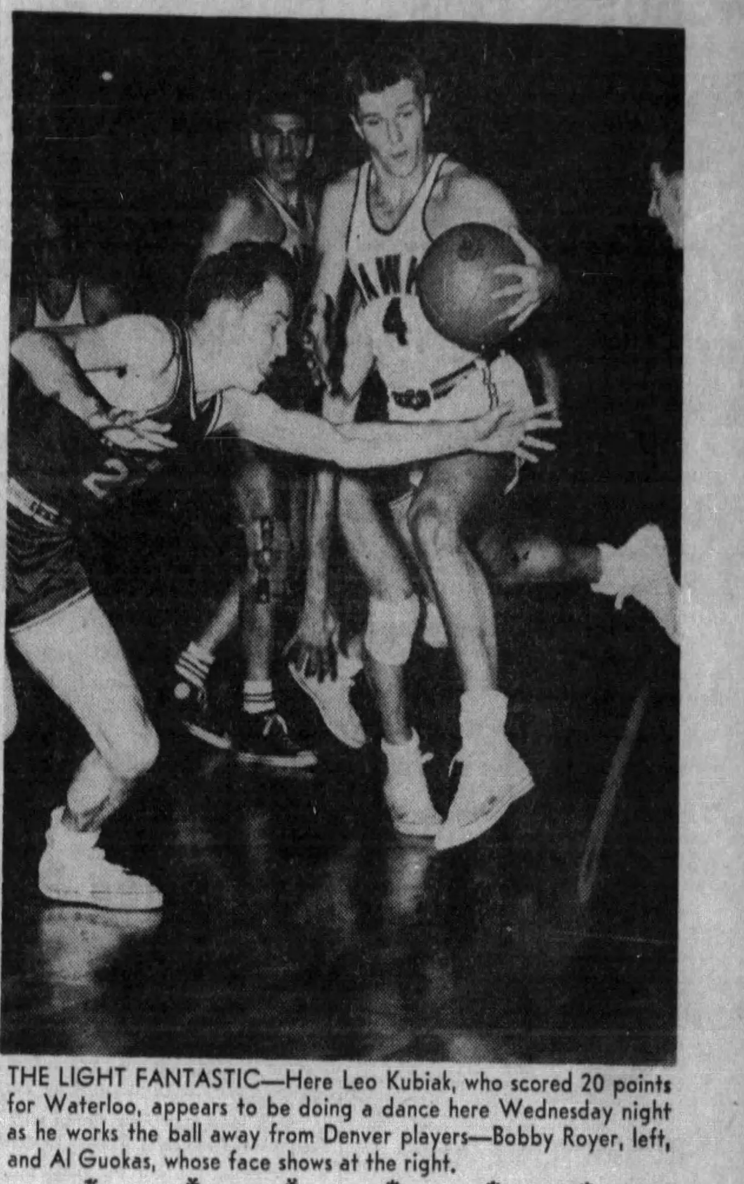 Waterloo's Leo Kubiak goes past Denver's Bobby Royer and Al Guokas